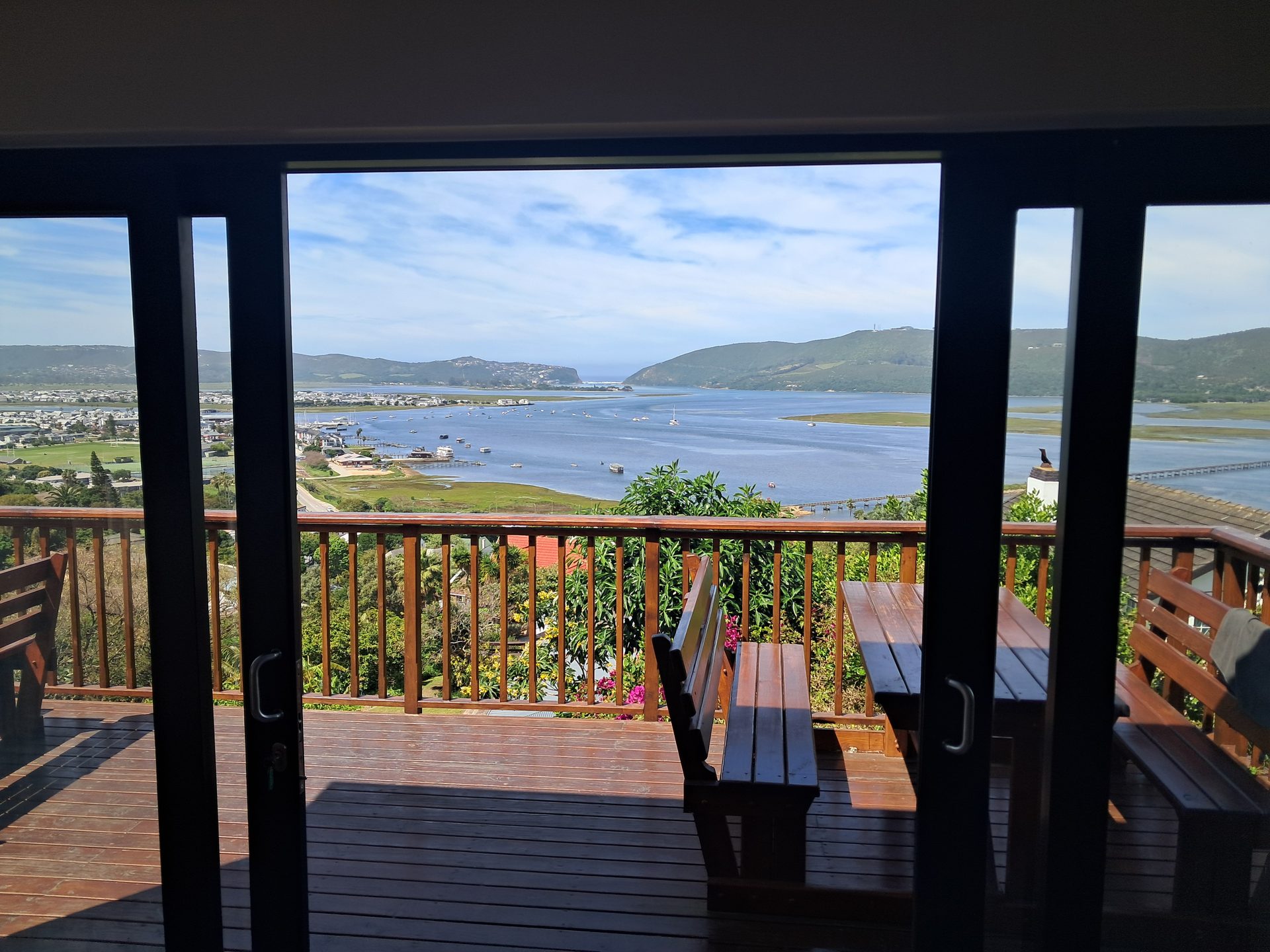 Knysna Paradise deck with a picnic table and the Knysna Lagoon beyond