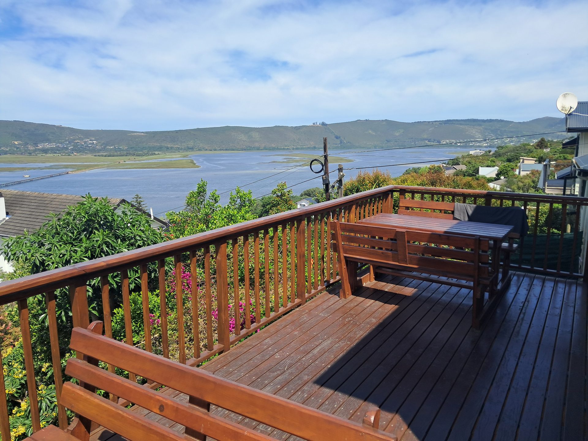 Wide wooden deck at Knysna Paradise with lagoon and bridge views