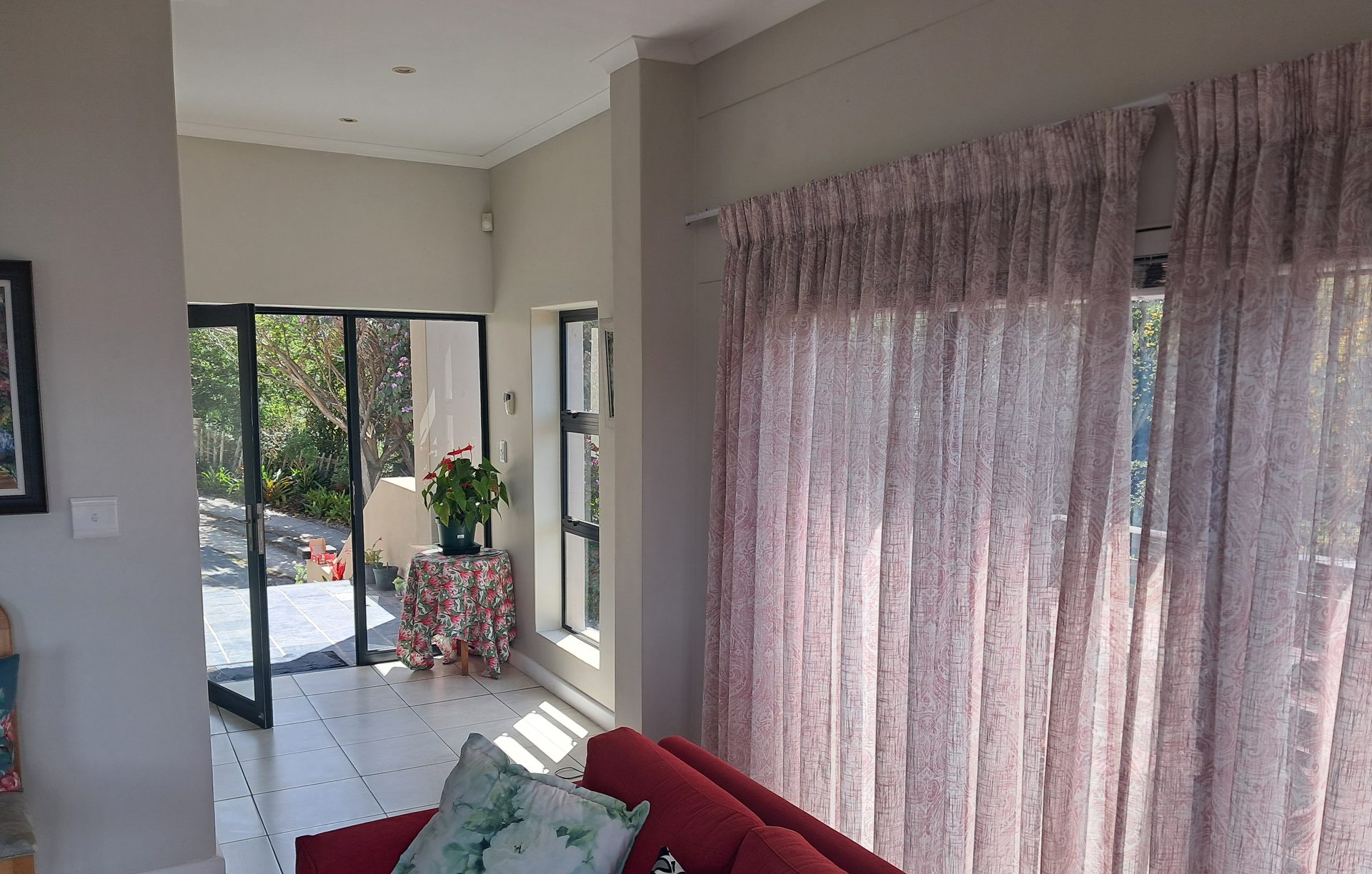 Guest lounge opening onto the sunny patio at Knysna Paradise